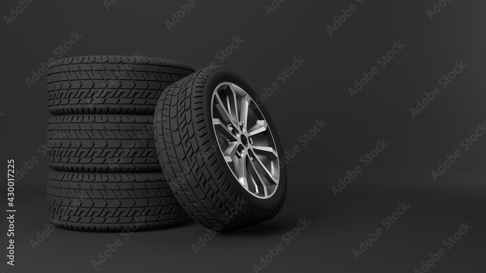 Sports car wheels stacked on top of each other, on a black background.