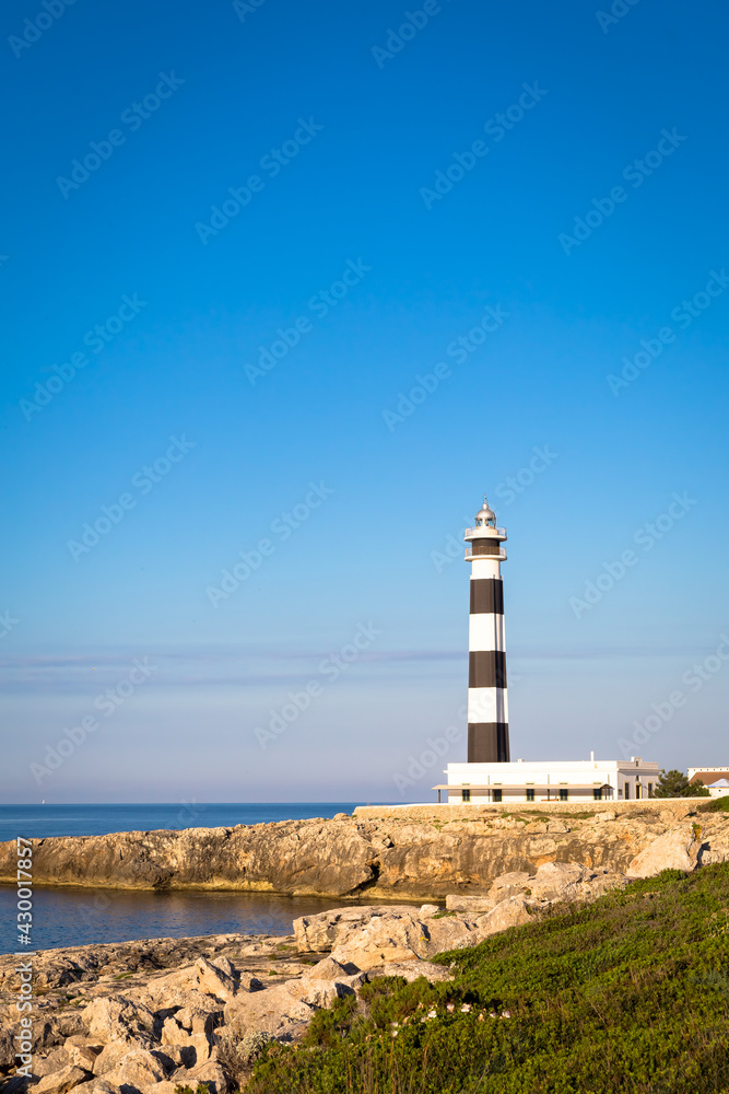 Scenic Artrutx Lighthouse at sunset in Minorca, Spain