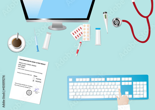 Top view of a medical table with accessories. Finger is touching computer keyboard.