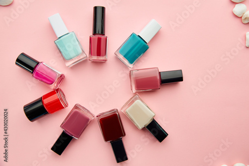 Nail care products, polish on pink background