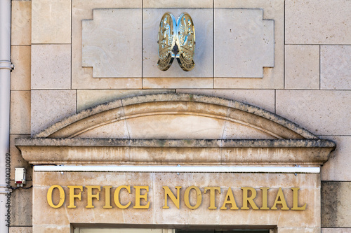 Traditional brace sign above the main entrance of an Office notarial (sollicitor).