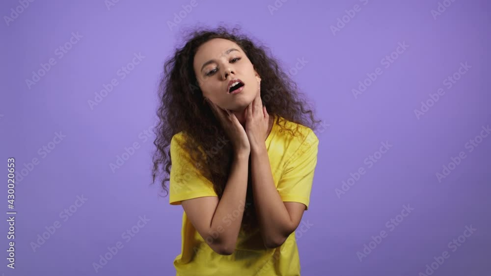 Young tired woman is dissatisfied, unhappy. She rolling eyes. Portrait of girl with curly hair, she exhales from stuffiness, bored because of work or study. Young tired woman is dissatisfied, unhappy. She rolling eyes. Portrait of girl with curly hair, she exhales from stuffiness, bored because of work or study.