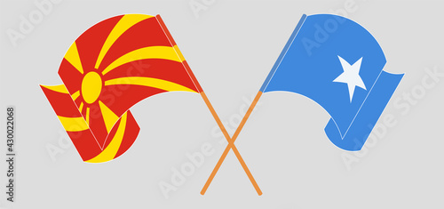 Crossed and waving flags of North Macedonia and Somalia