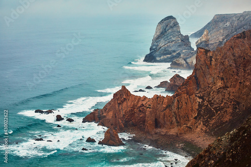 Cliffs shrouded in mist in the Atlantic Ocean, natural landscape on Cabo da Roca near the city of Cascais, Portugal
