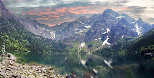 Wide angle shot of Misty and rainy view of mountain landscape, beautiful day with dramatic sky in Morskie Oko, Zakopane located in south Poland.