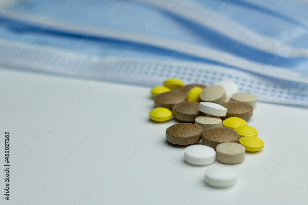 Closeup of supplements for the immune system and medical masks. Closeup of supplements for the immune system and medical masks.