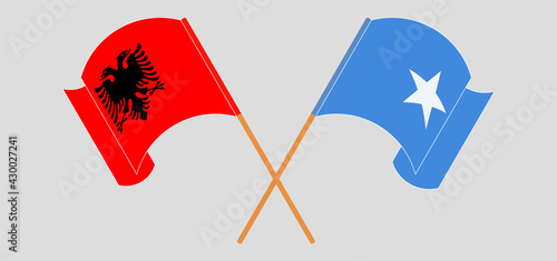 Crossed and waving flags of Albania and Somalia
