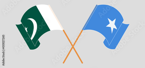 Crossed and waving flags of Pakistan and Somalia