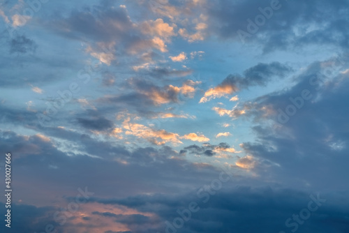 Fototapeta Naklejka Na Ścianę i Meble -  The sky at sunset. Cumulus clouds lit by the rays of the setting sun.
