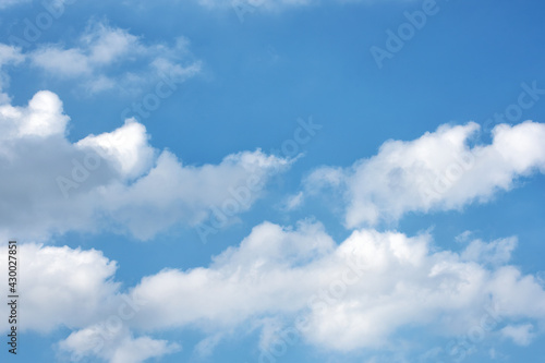 Fluffy white clouds on background of blue sky. © Sergei