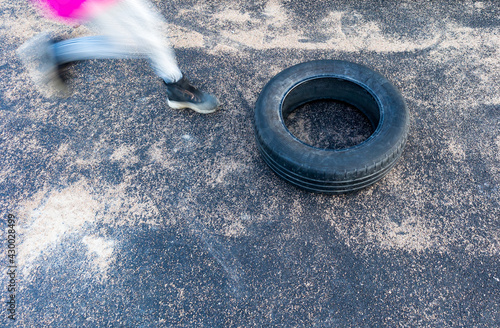Obstacle race child jumping through tire playing