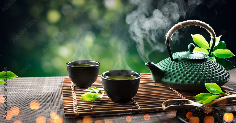 Asian Tea Set. Hot Tea In Pot And Teacups. Japanese Teapot And Cups On  Bamboo Mat Stock Photo, Picture and Royalty Free Image. Image 200564531.