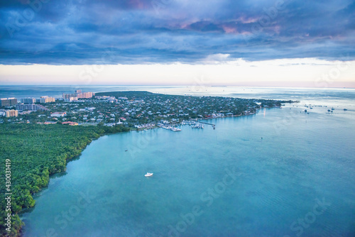 A body of water with buildings and trees around it  aerial view