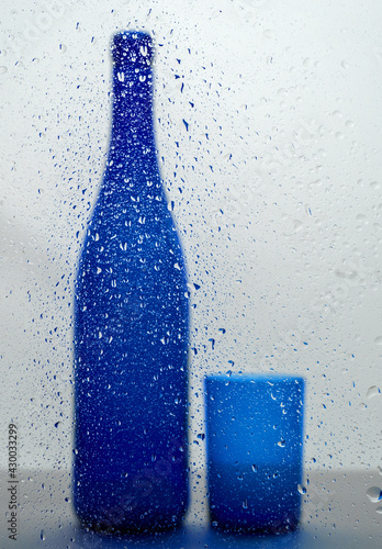 bottle throw the glass with drops