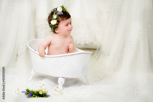 Little girl bathes in the bathroom
