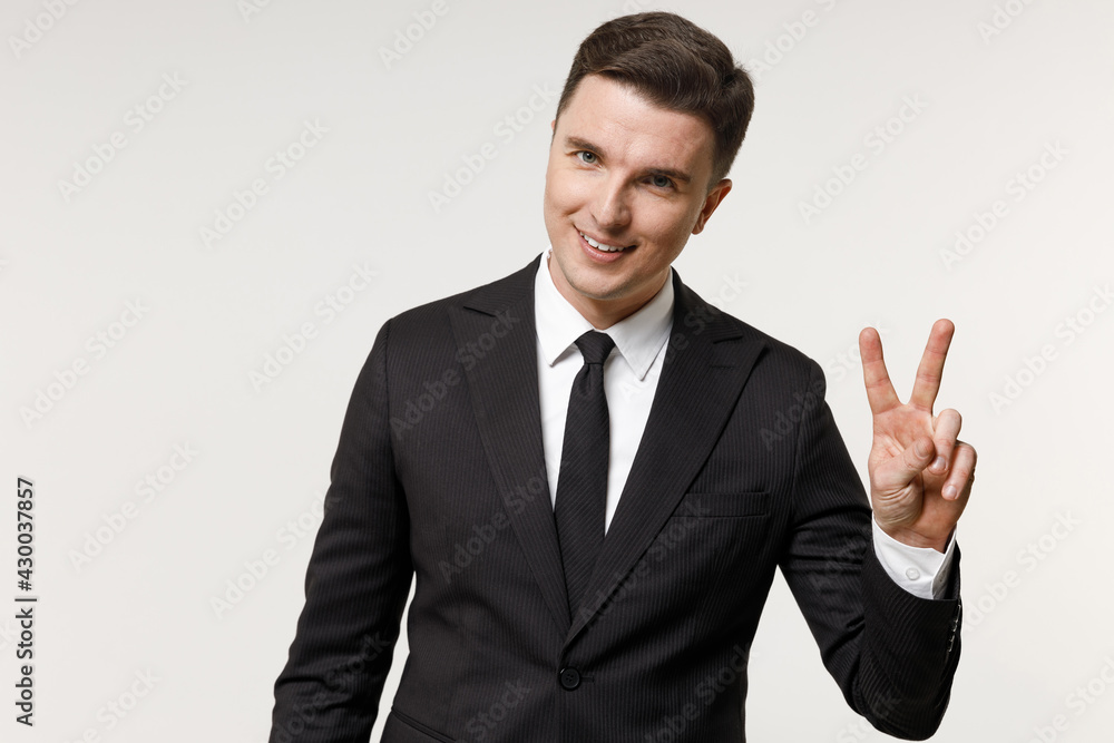 Young caucasian successful employee business corporate lawyer man in classic formal black grey suit shirt tie work in office show victory v-sign gesture isolated on white background studio portrait. Young caucasian successful employee business corporate lawyer man in classic formal black grey suit shirt tie work in office show victory v-sign gesture isolated on white background studio portrait.