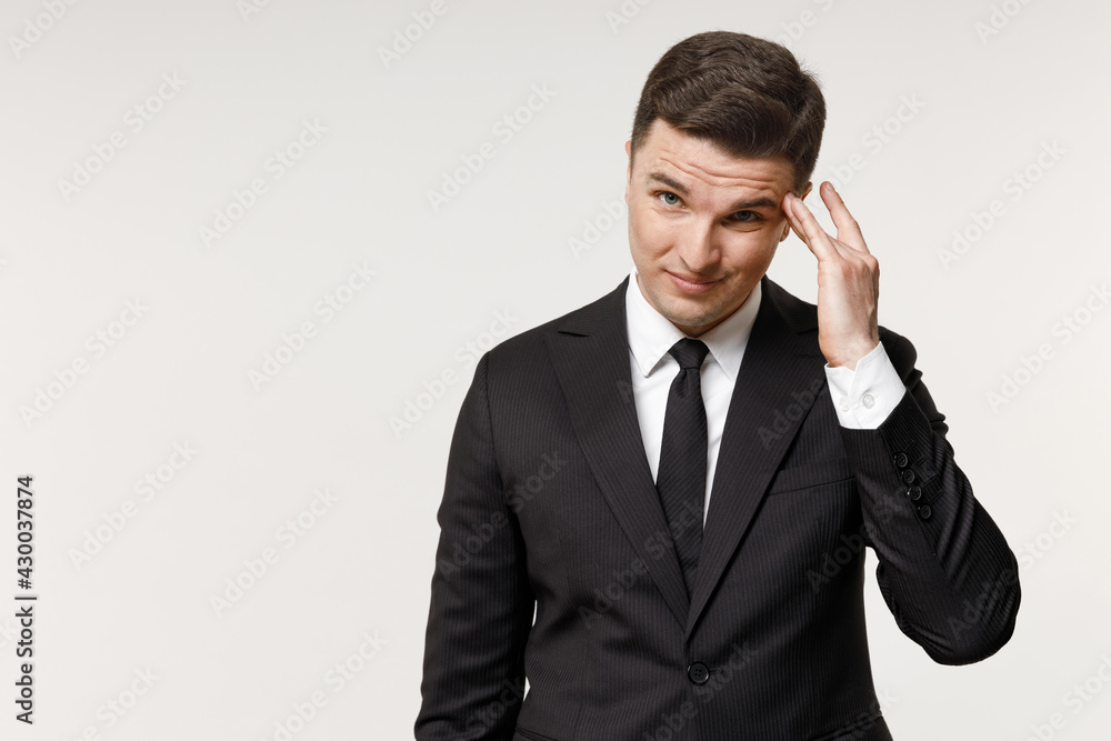 Young puzzled employee business corporate lawyer man 20s wearing classic formal black grey suit shirt tie working in office prop up forehead look camera isolated on white background studio portrait Young puzzled employee business corporate lawyer man 20s wearing classic formal black grey suit shirt tie working in office prop up forehead look camera isolated on white background studio portrait