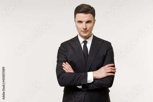 Young caucasian successful employee business corporate lawyer man 20s in classic formal black grey suit shirt tie work in office hold hands crossed folded isolated on white background studio portrait