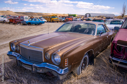Exterior of a junked vintage retro vehicle in a junkyard.