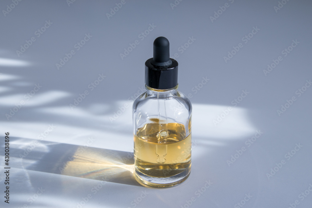 Glass dropper bottle in trendy shades. Body and spa treatments. Greasy cosmetics, eco cream, serum, empty bottle for skin care. Anti-cellulite massage oil in a bottle with a pipette Glass dropper bottle in trendy shades. Body and spa treatments. Greasy cosmetics, eco cream, serum, empty bottle for skin care. Anti-cellulite massage oil in a bottle with a pipette
