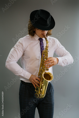 Portrait of a man playing the saxophone.