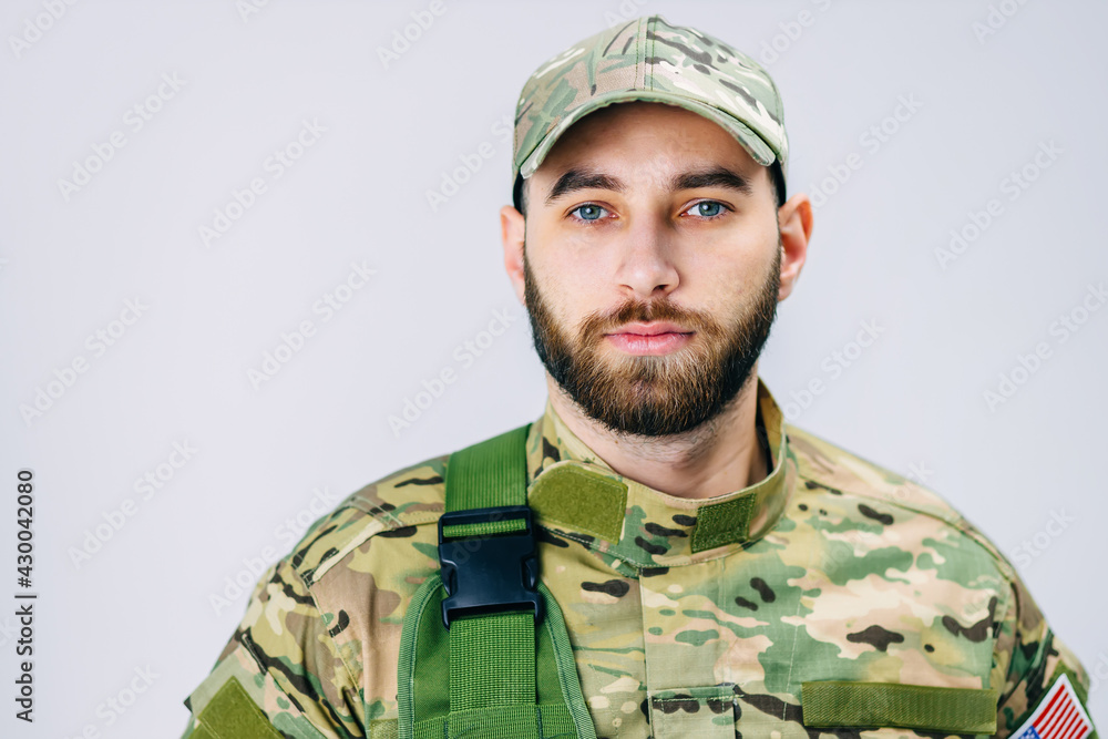 Close up view of a serious soldier in military uniform looking a Close up view of a serious soldier in military uniform looking a