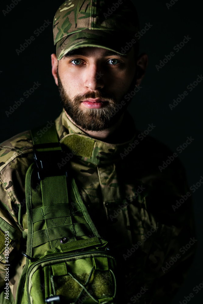 Close-up of a naval American soldier. He wears a tactical uniform. The expression on the man's face shows fatigue and frustration. Close-up of a naval American soldier. He wears a tactical uniform. The expression on the man's face shows fatigue and frustration.