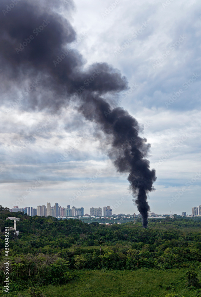 A huge black column of smoke and skyline, Rio