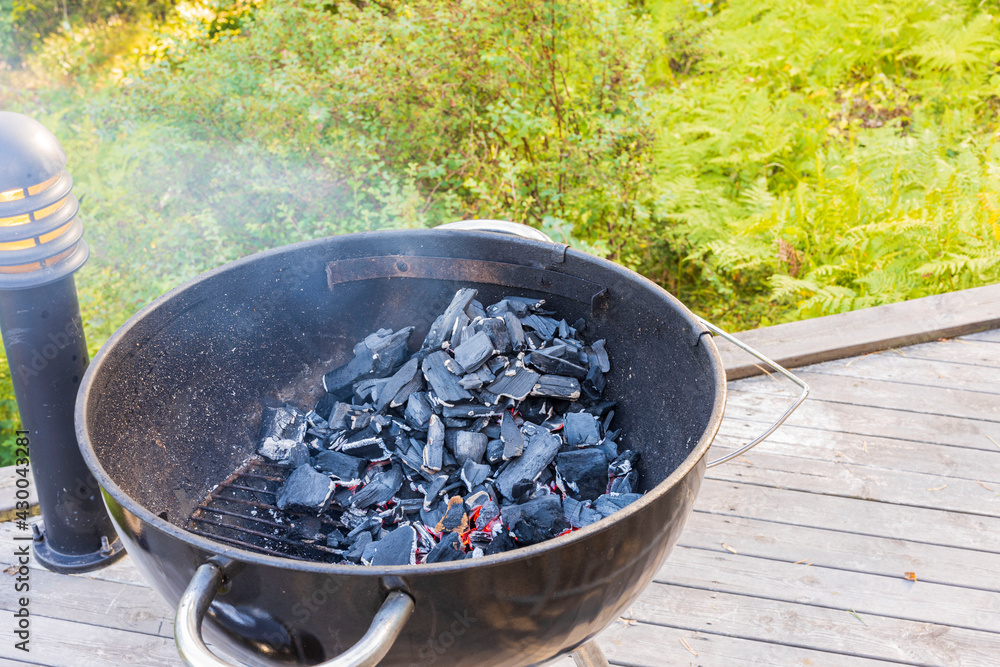 Close up view of embers in grill on patio. Sweden. Close up view of embers in grill on patio. Sweden.