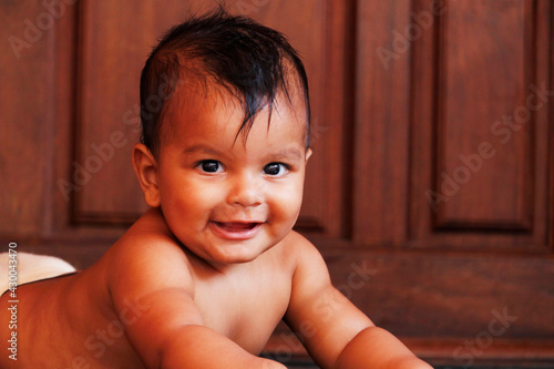 young indian baby boy looking with smily face photo