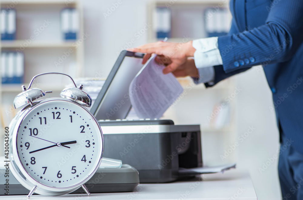 Businessman making copies in copying machine Businessman making copies in copying machine
