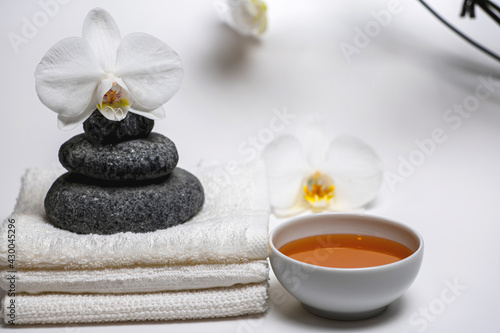 spa style  white towels  honey cup  Zen stones  orchid  everything for a relaxing massage