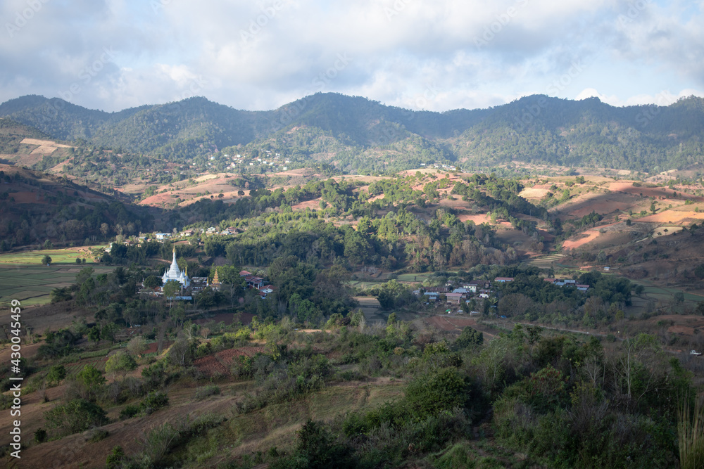 A white pagoda by rolling hills between Kalaw and Inle Lake