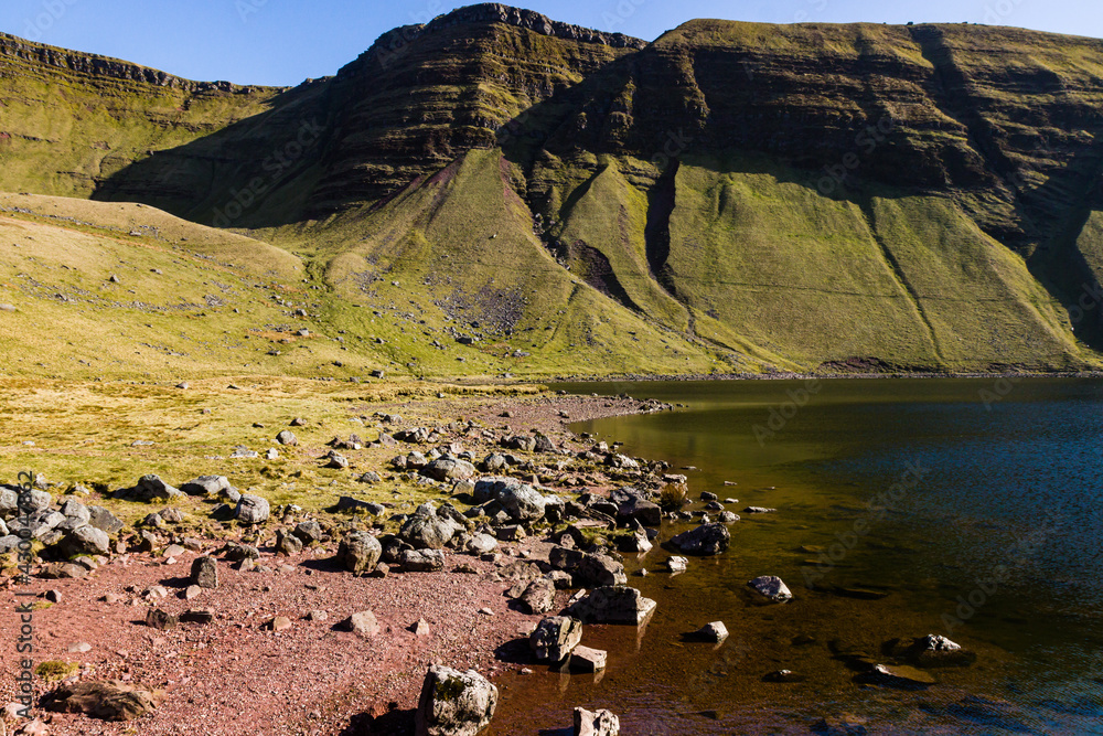 A small lake at the foot of mountains in the Brecon Beacons (Llyn y Fan Fach, Wales)