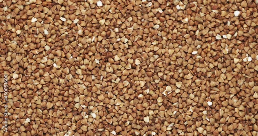 Closeup buckwheat groats rotation, background, texture. Slow motion. Food background. Closeup buckwheat groats rotation, background, texture. Slow motion. Food background.