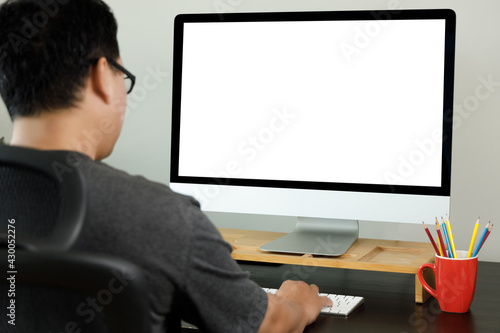 Laptop or notebook with blank screen man work from home On Laptop computer in a modern room at office desk