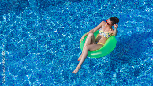 young attractive woman in swimwear has fun in swimming pool