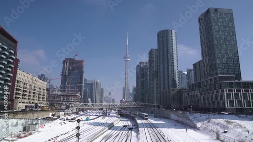 Toronto downtown, CN Tower, condo buildings, train railway transportation during winter photo