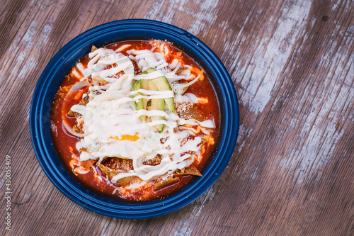 top view of red chilaquiles on a plate