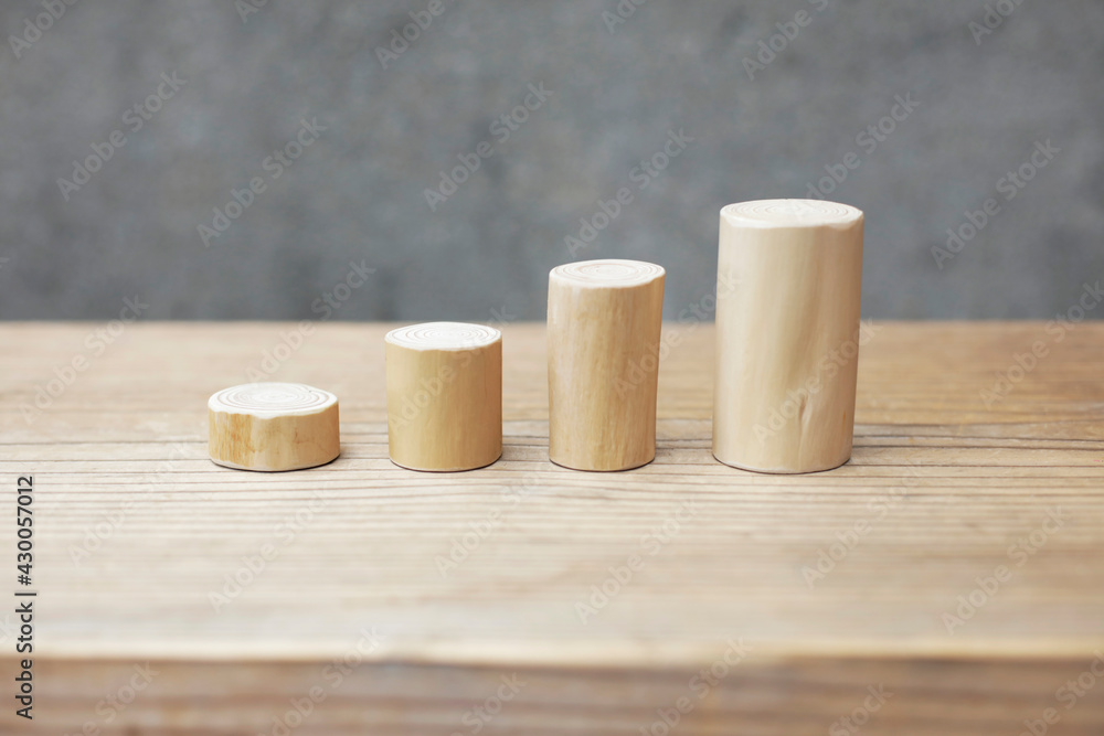 Thin and short barkless wooden log blocks on wooden table. Barkless