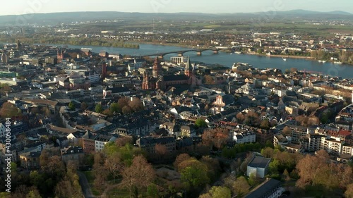 Mainz Drone Shot with the Cathedral church in the middle of old town with the blue Rhine river in the back