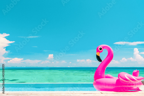 Travel Vacation Pool Beach travel concept with inflatable pink flamingo float toy mattress in luxury swimming pool. Luxury lifestyle summer holidays travel background © Maridav