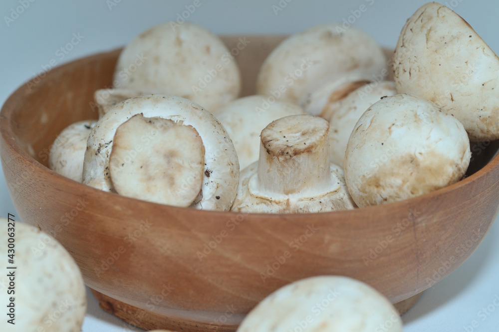 Mushrooms on a wooden chopping board on a white background Mushrooms on a wooden chopping board on a white background