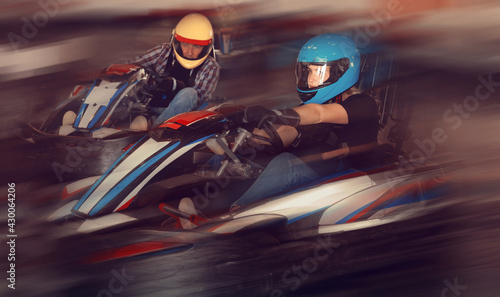 Adult woman driving sport car for karting in a circuit lap in sport club