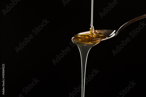 Pouring hemp oil into spoon.medical marijuana concept, CBD cannabis OIL, close up, Herbs for alternative medicine.