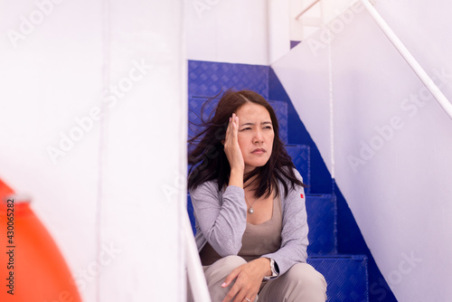 Obraz na plátne Woman suffering from sea sickness and feeling headache while on boat