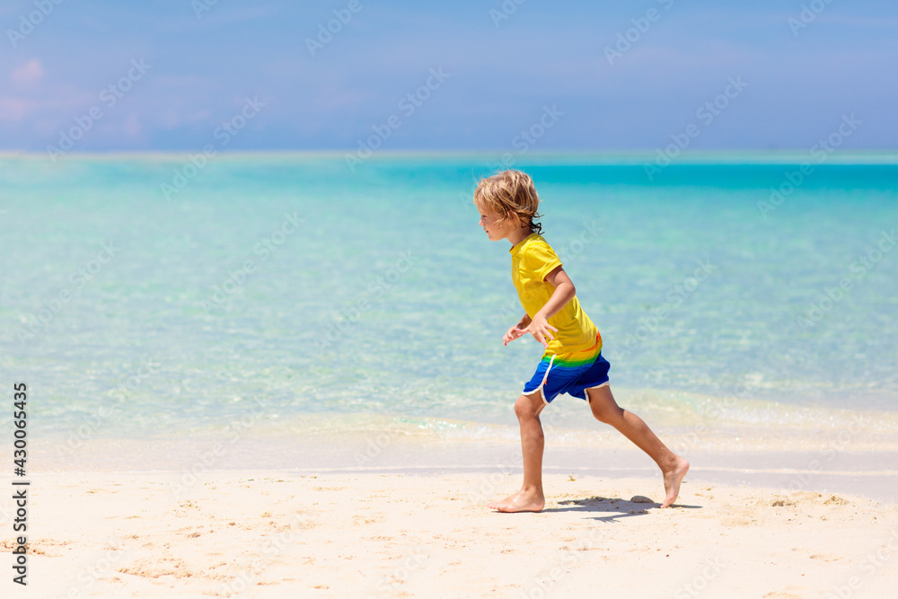 Kids playing on beach. Children play at sea.