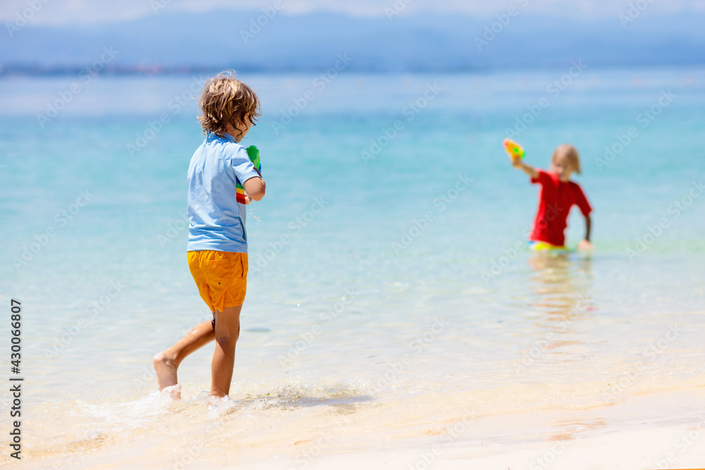 Child with toy water gun. Kids vacation beach fun. Child with toy water gun. Kids vacation beach fun.