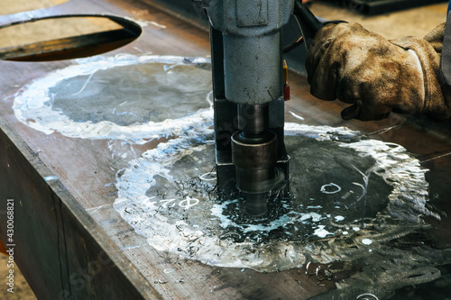 Craftsman used drill press is drilling the steel surface.