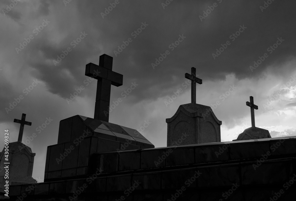 Cemetery or graveyard in the night. Haunted cemetery. Spooky burial ground. Horror scene of graveyard. Funeral and cemetery rules during coronavirus. Grave crisis. Coronavirus guidance for cemetery.